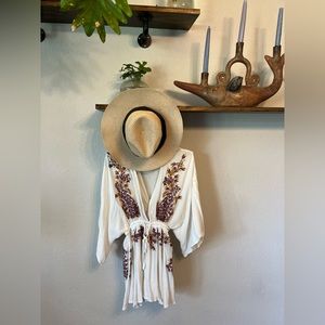 Super beachy vibes with this embroidered romper with a tie waist.